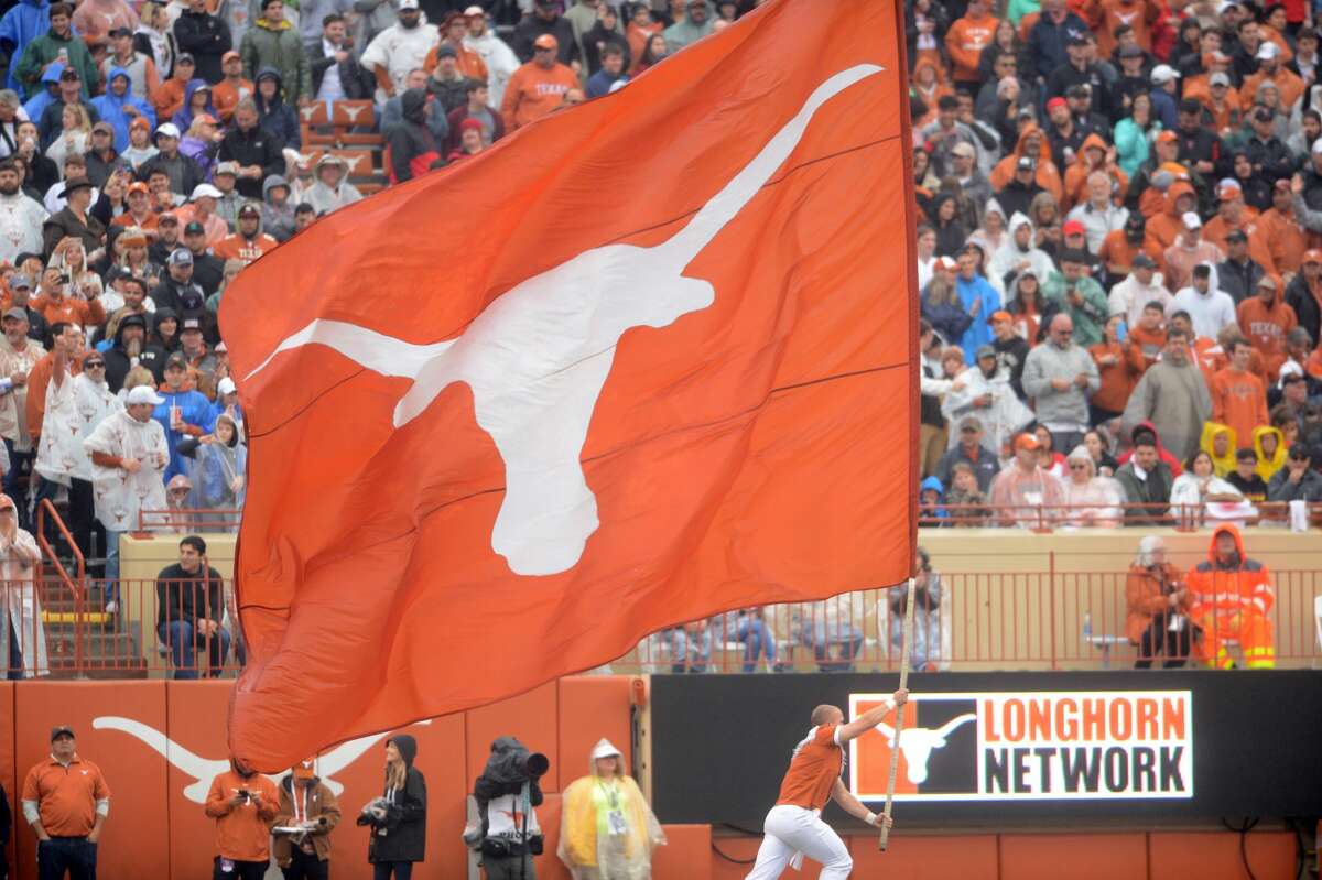 A Texas Longhorns spirit member runs with a flag during game against the Texas Tech Red Raiders on November 29, 2019 at Darrell K Royal-Texas Memorial Stadium in Austin, Texas.