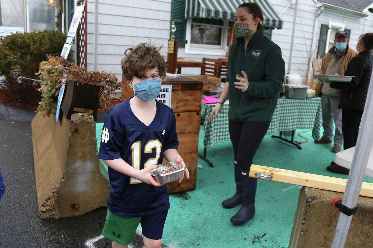 Jack Brennan, 9, of Darien, leaves Rory's with his dessert in hand during the Something Sweet on Tour event on Saturday, Feb. 27, 2021.