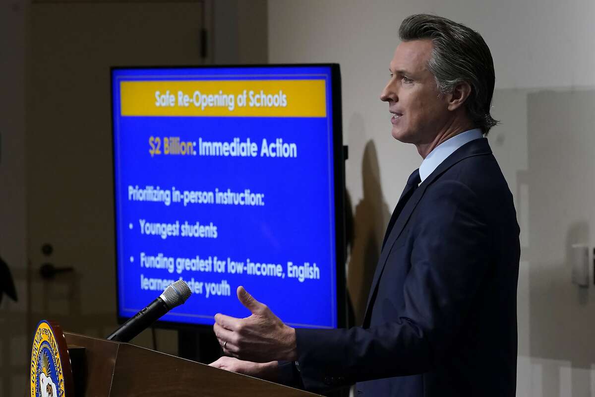 Gov. Gavin Newsom outlines his earlier plan for widespread reopening of schools at a Jan. 8 news conference in Sacramento. Newsom and legislative leaders have reached a new deal for returning some students to classrooms by the end of March.