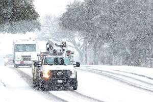 CPS Energy work crews were seen driving along Vance Jackson Road during another day of snow fall in San Antonio on Thursday, Feb 18, 2021.