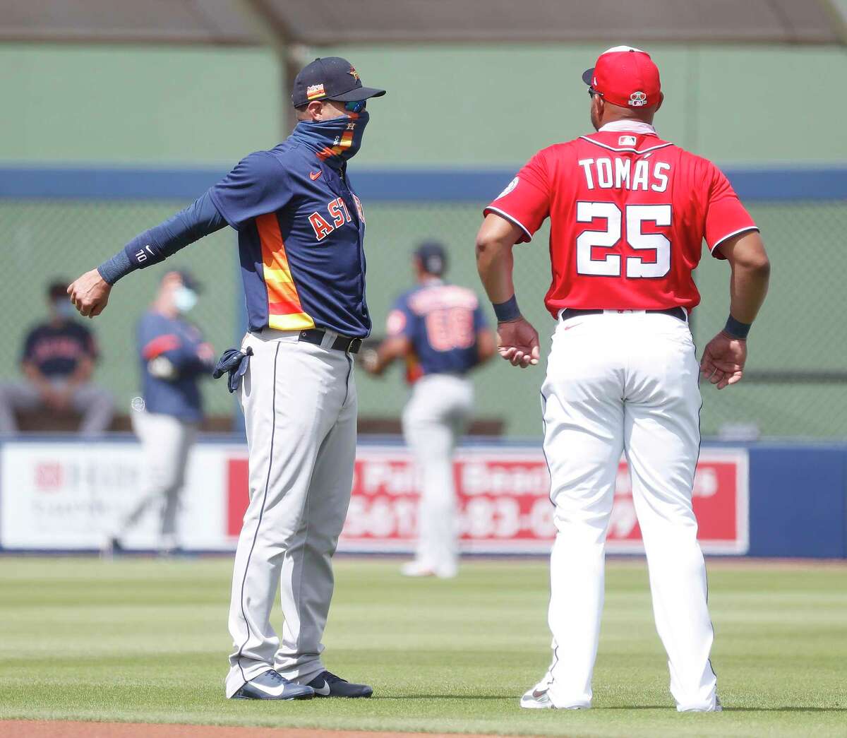 Houston Astros Yuli Gurriel (10) chats with Washington Nationals Yasmany Tomas (25) before the start of the first inning of an MLB spring training game at Ballpark of the Palm Beaches in West Palm Beach, Florida, Monday, March 1, 2021.