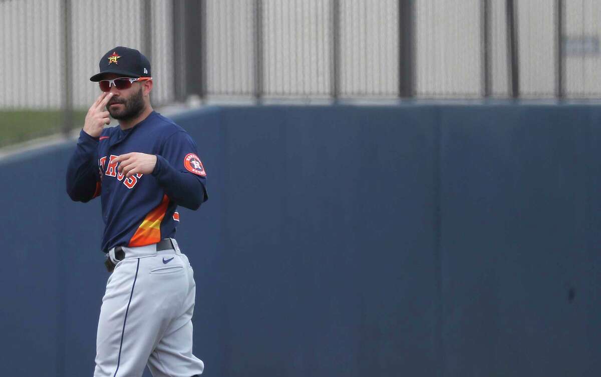 Houston Astros second baseman Jose Altuve (27) signals someone in the Washington Nationals dugout before the start of the first inning of an MLB spring training game at Ballpark of the Palm Beaches in West Palm Beach, Florida, Monday, March 1, 2021.