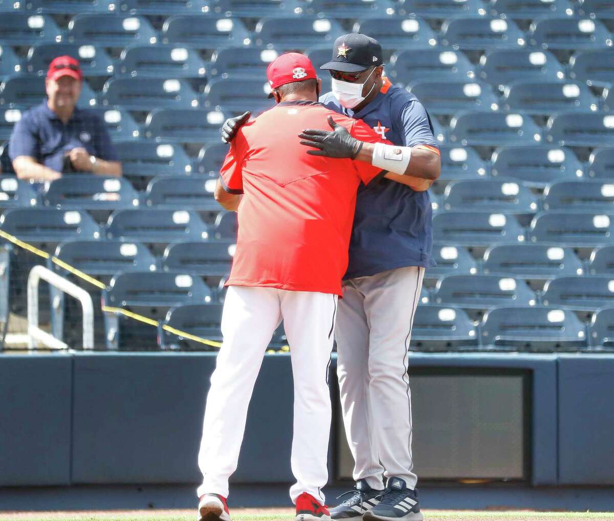 Houston Astros manager Dusty Baker hugs Washington Nationals manager Dave Martinez before the start of the first inning of an MLB spring training game at Ballpark of the Palm Beaches in West Palm Beach, Florida, Monday, March 1, 2021.