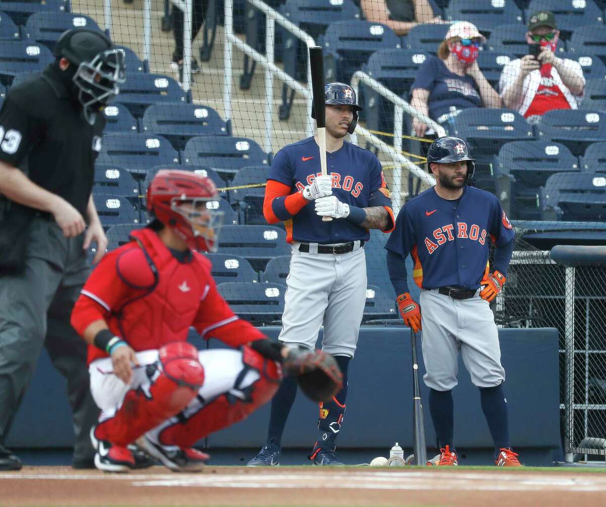 Houston Astros Carlos Correa (1) and Jose Altuve (27) watch Washington Nationals starting pitcher Austin Voth warm up before the start of the first inning of an MLB spring training game at Ballpark of the Palm Beaches in West Palm Beach, Florida, Monday, March 1, 2021.