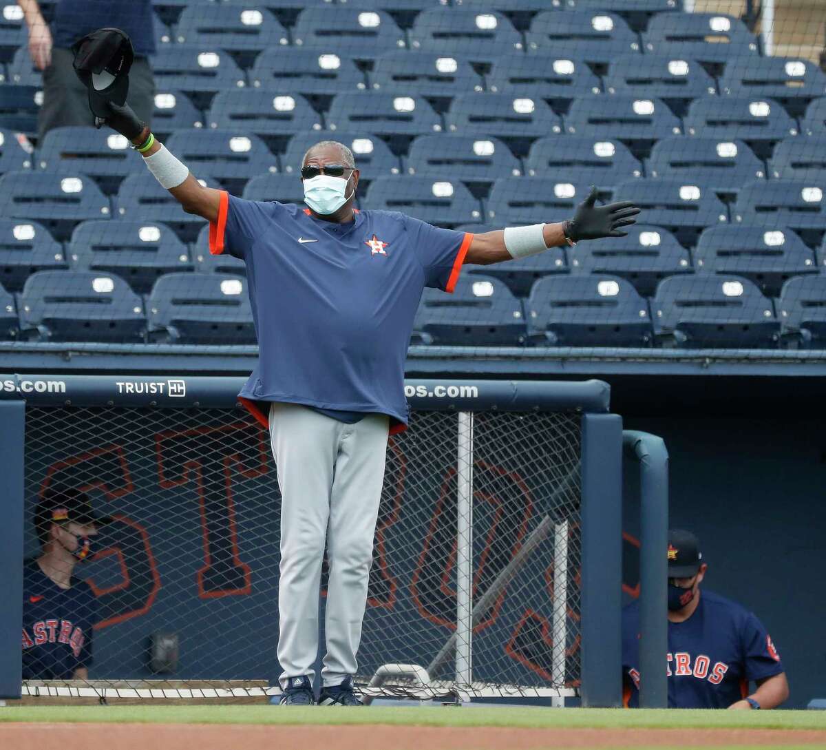Houston Astros manager Dusty Baker opens his arms wide for Washington Nationals manager Dave Martinez before the start of the first inning of an MLB spring training game at Ballpark of the Palm Beaches in West Palm Beach, Florida, Monday, March 1, 2021.