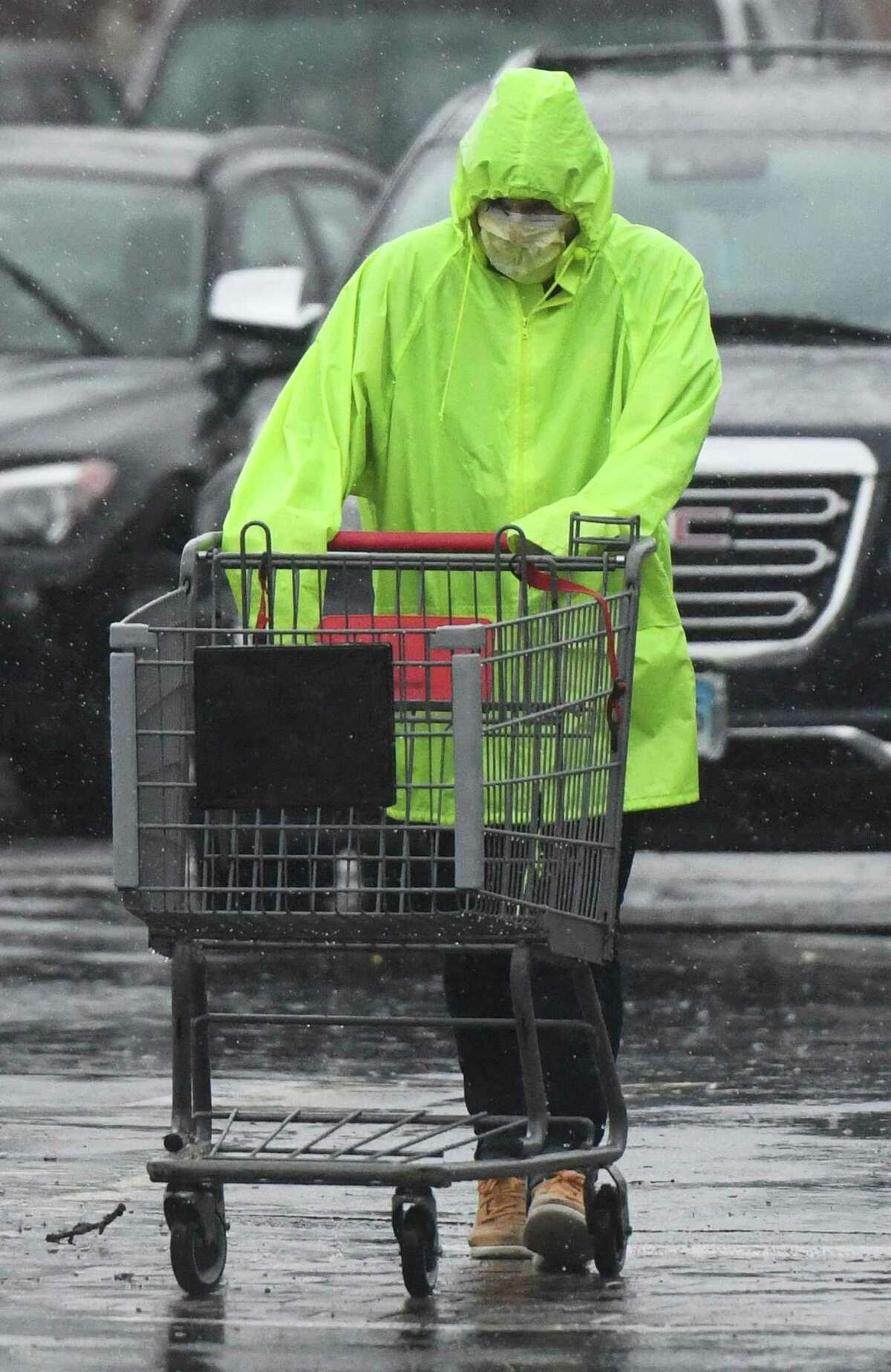 A file photo of a worker pushing a cart in the parking lot of the Riverside Commons shopping center in the Riverside section of Greenwich, Conn.