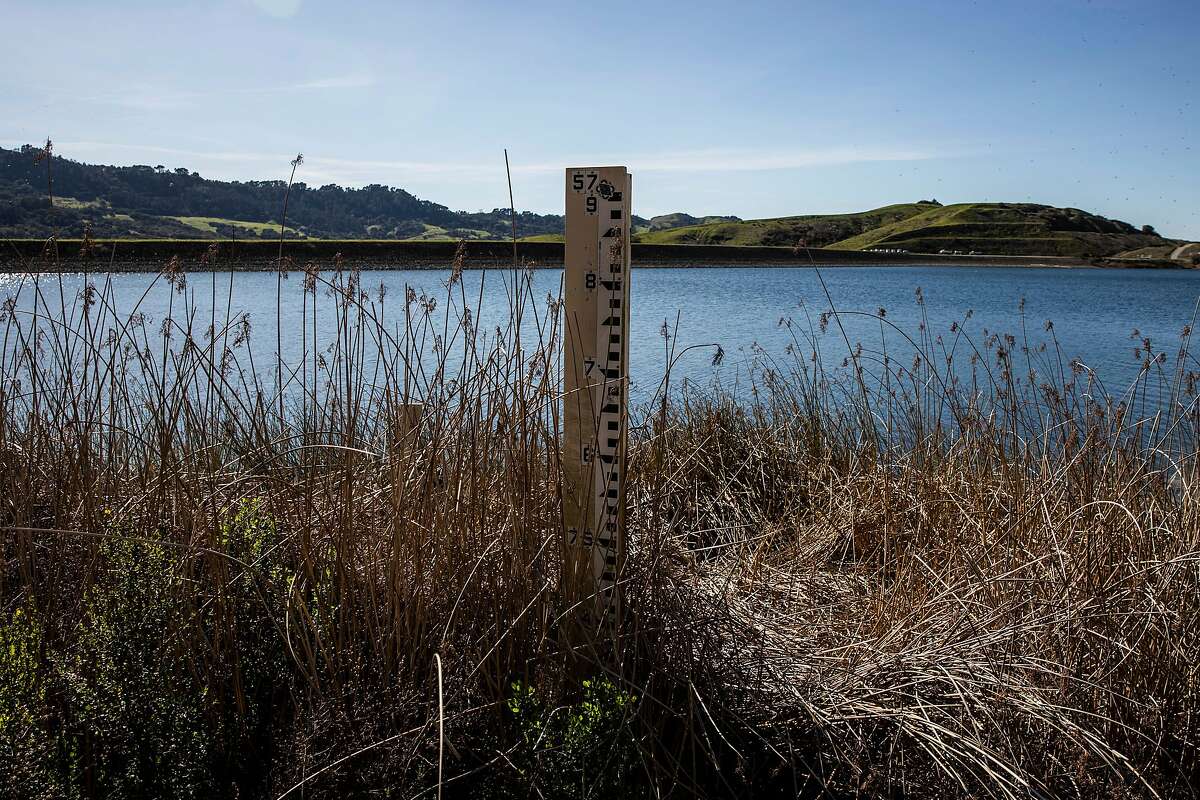 A depth gauge stands partially exposed at Briones Reservoir in Orinda on Feb. 28, 2021.