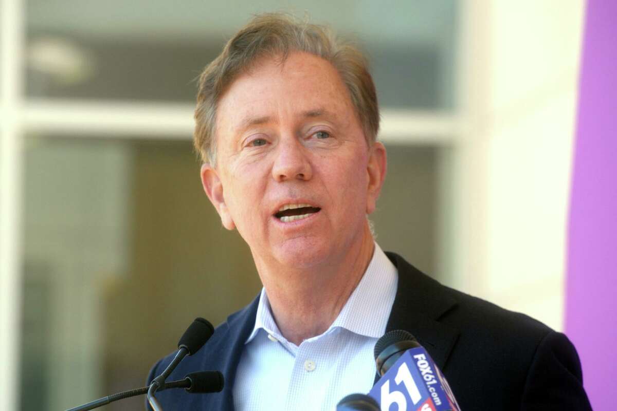 Gov. Ned Lamont speaks during a news conference in front of St. Vincent’s Medical Center, in Bridgeport, Conn. Feb. 26, 2021. Nine black and Latino clergy members from various Bridgeport ministries received COVID-19 vaccinations at the Friday event.