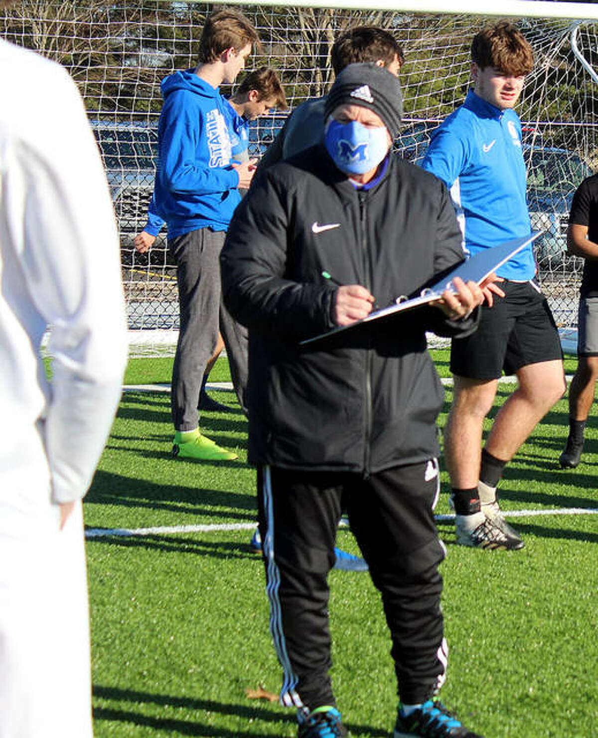 New Marquette catholic high boys soccer coach Jerry DiSalvo gathers his players for the first official preseason practice Monday at Gordon Moore Park.