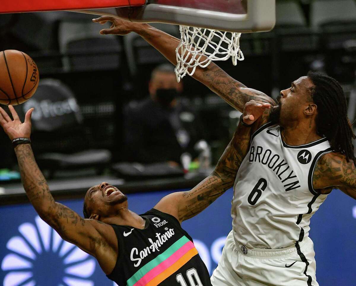 DeAndre Jordan (6) of the Brooklyn Nets plays a tough defense as DeMar DeRozan (10) of the San Antonio Spurs attempts a layup during NBA action in the AT&T Center on Monday, March 1, 2021.