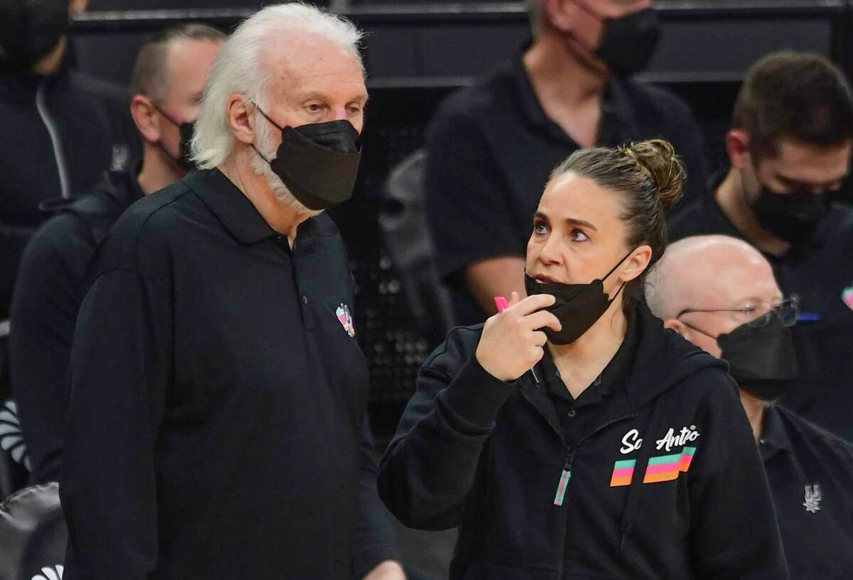 San Antonio Spurs head coach Gregg Popovich and assistant Becky Hammon converse during second-half NBA action in the AT&T Center on Monday, March 1, 2021.