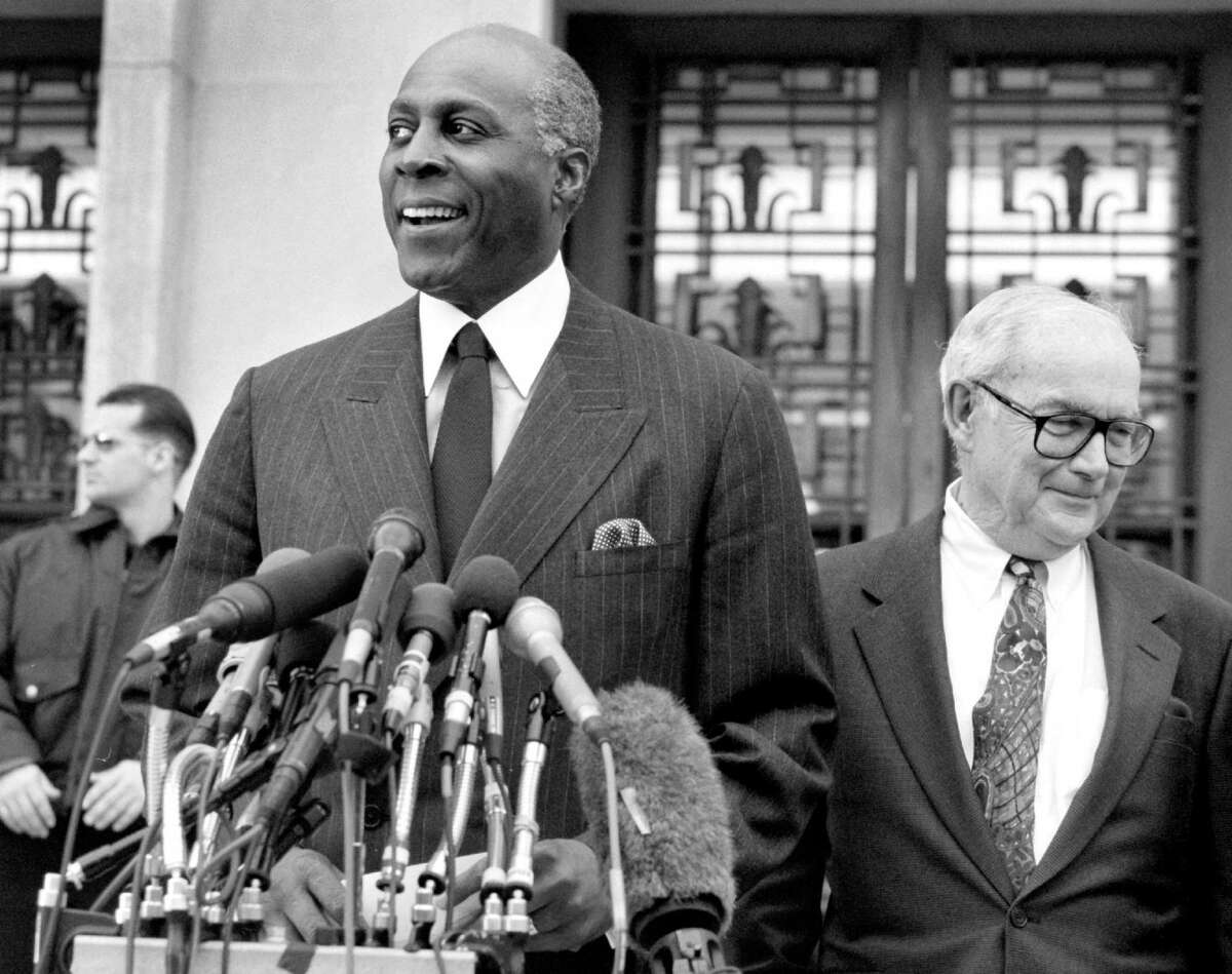 Vernon Jordan, left, a confidant of President Bill Clinton's, exits a courthouse in Washington, D.C., after testifying before a grand jury in 1998.