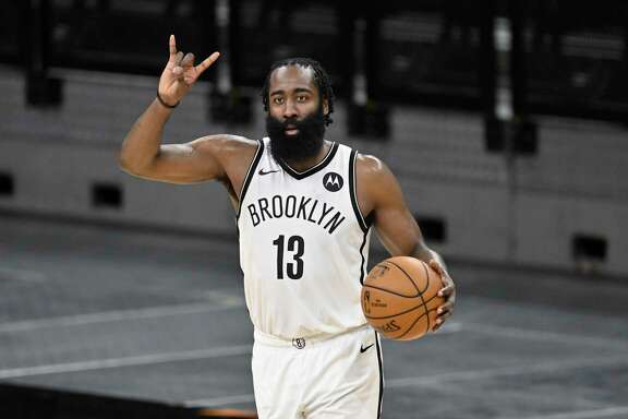 Brooklyn Nets' James Harden signals to teammates during the second half of an NBA basketball game against the San Antonio Spurs, Monday, March 1, 2021, in San Antonio. Brooklyn won 124-113. (AP Photo/Darren Abate)