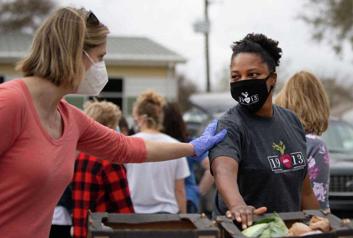 Fort Bend County resident and volunteer Stevie Irby, left, thanks chef Dawn Burrell, right, for helping to prepare thousands of meals for people in need at the North Richmond Neighborhood Resource Center, Wednesday, Feb. 24, 2021, in Richmond. The food distribution event is one of several taking place in southeast Texas after the state and its residents suffered deprivation during Winter Storm Uri.
