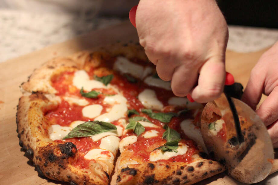 Neapolitan style pizzas with a variety of toppings cooked in a wood-fired oven is one of the specialty items available at Vita Bella in Frankfort. Photo: Courtesy Photo