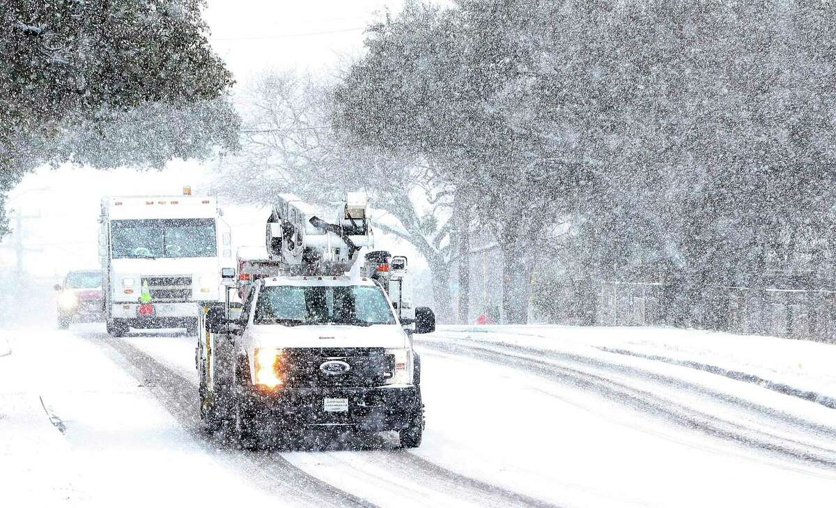 CPS Energy work crews drive in the snow Feb. 18. CPS says its costs in the wake of last month’s deadly winter storm include about $800 million owed to natural gas suppliers.