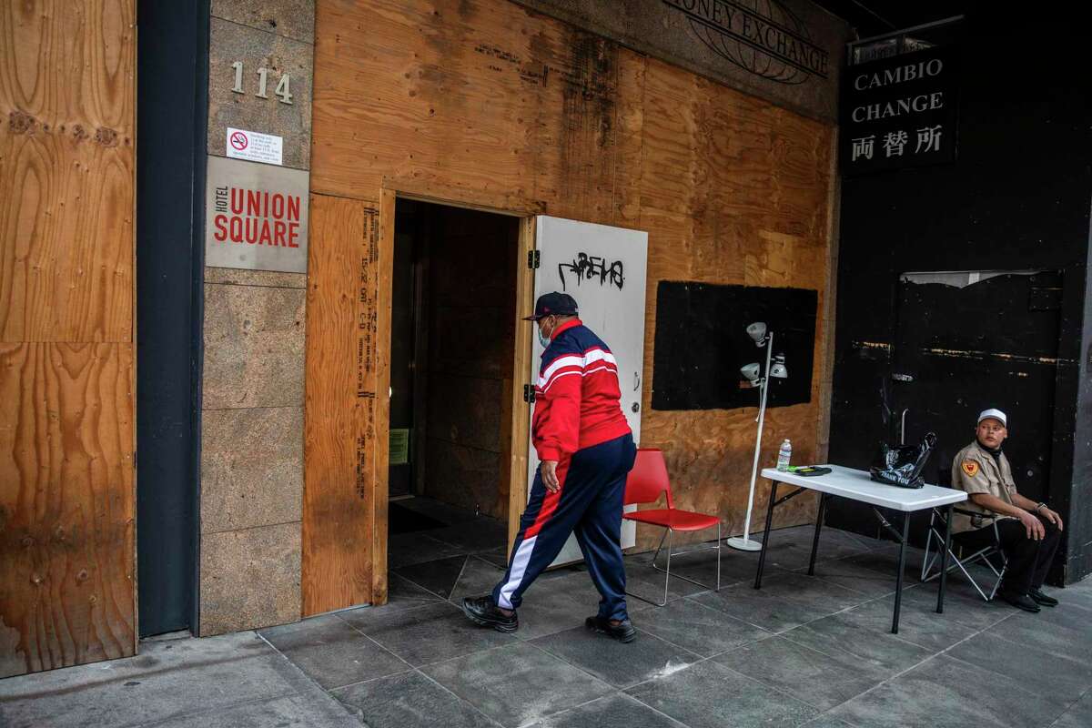 FILE-Marlin Tanner, 70, enters a shelter-in-place hotel near Union Square in San Francisco, California Tuesday, Mar. 2, 2021. Formerly incarcerated with diabetes, glaucoma and lower back pain, Tanner has been living at the shelter-in-place hotel for about a year after being injured in a drive-by shooting while living out of his car in the Bayview district.