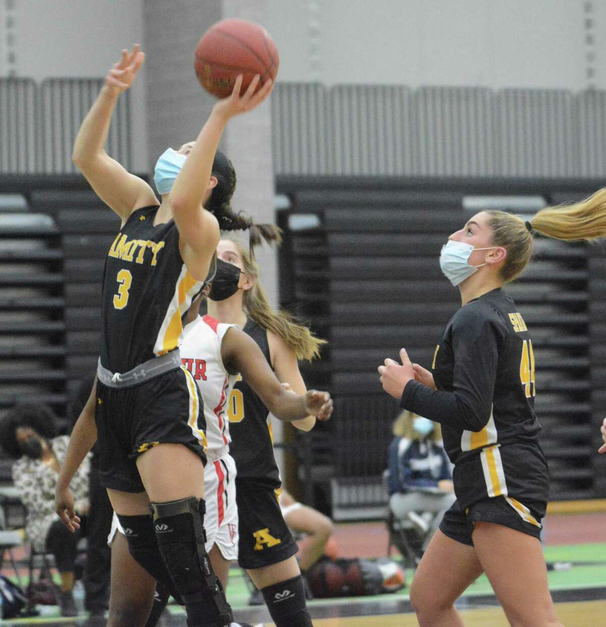 Amity Regional’s Skylar Burzynski (3) shoots as teammate Ribecka Marchitto (44) looks on during a girls basketball game against Wilbur Cross on Tuesday, March 2, 2021 in New Haven, Conn.