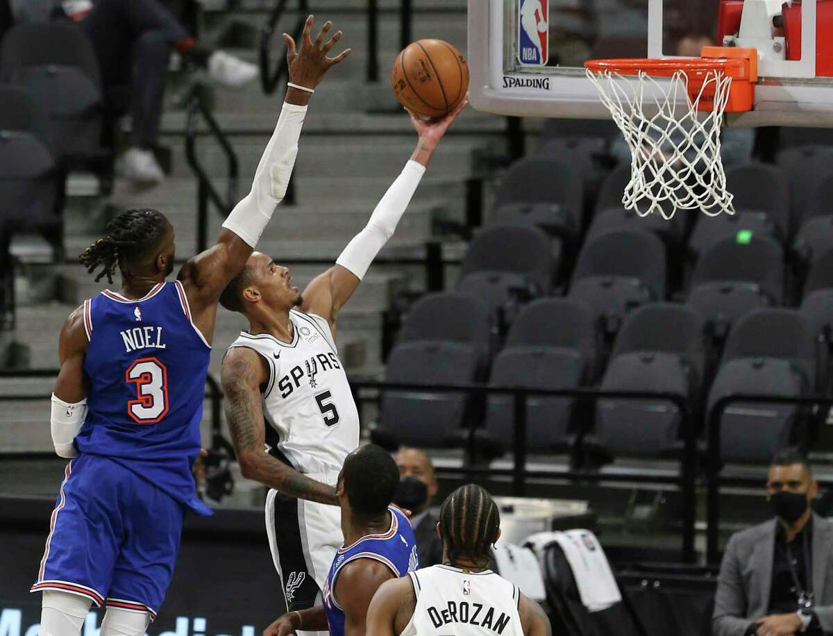 Spurs' Dejounte Murray (05) scores against New York Knicks' Nerlens Noel (03) at the AT&T Center on Tuesday, Mar. 2, 2021. Spurs defeated the Knicks, 119-93.