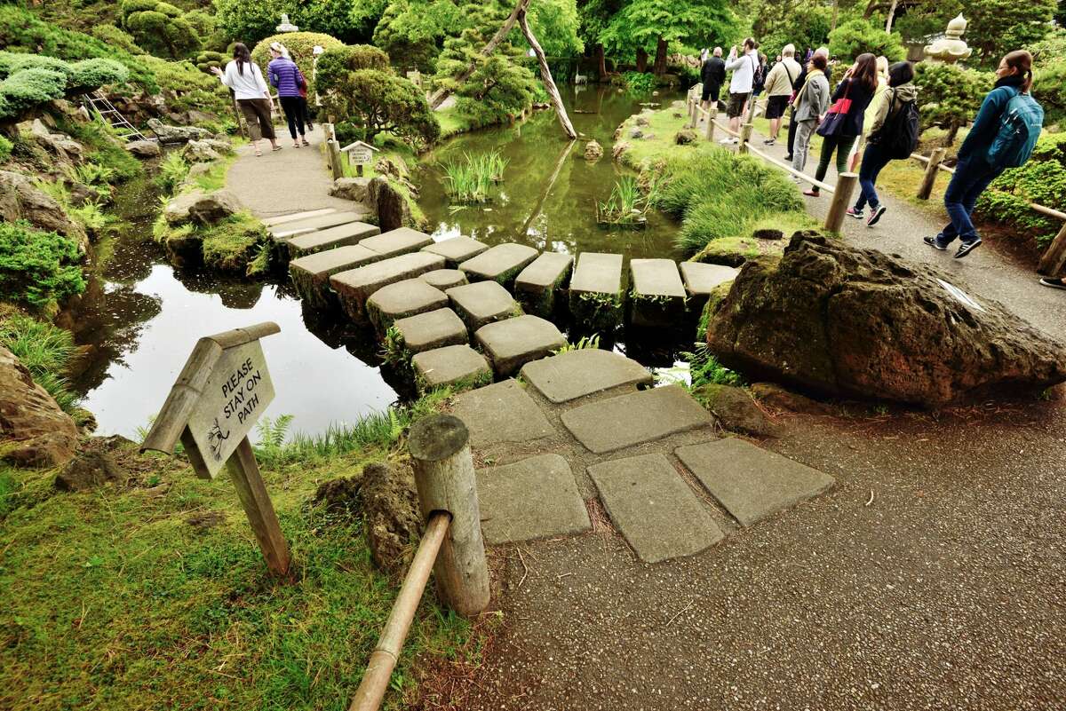 Visitors walk through the Japanese tea garden.