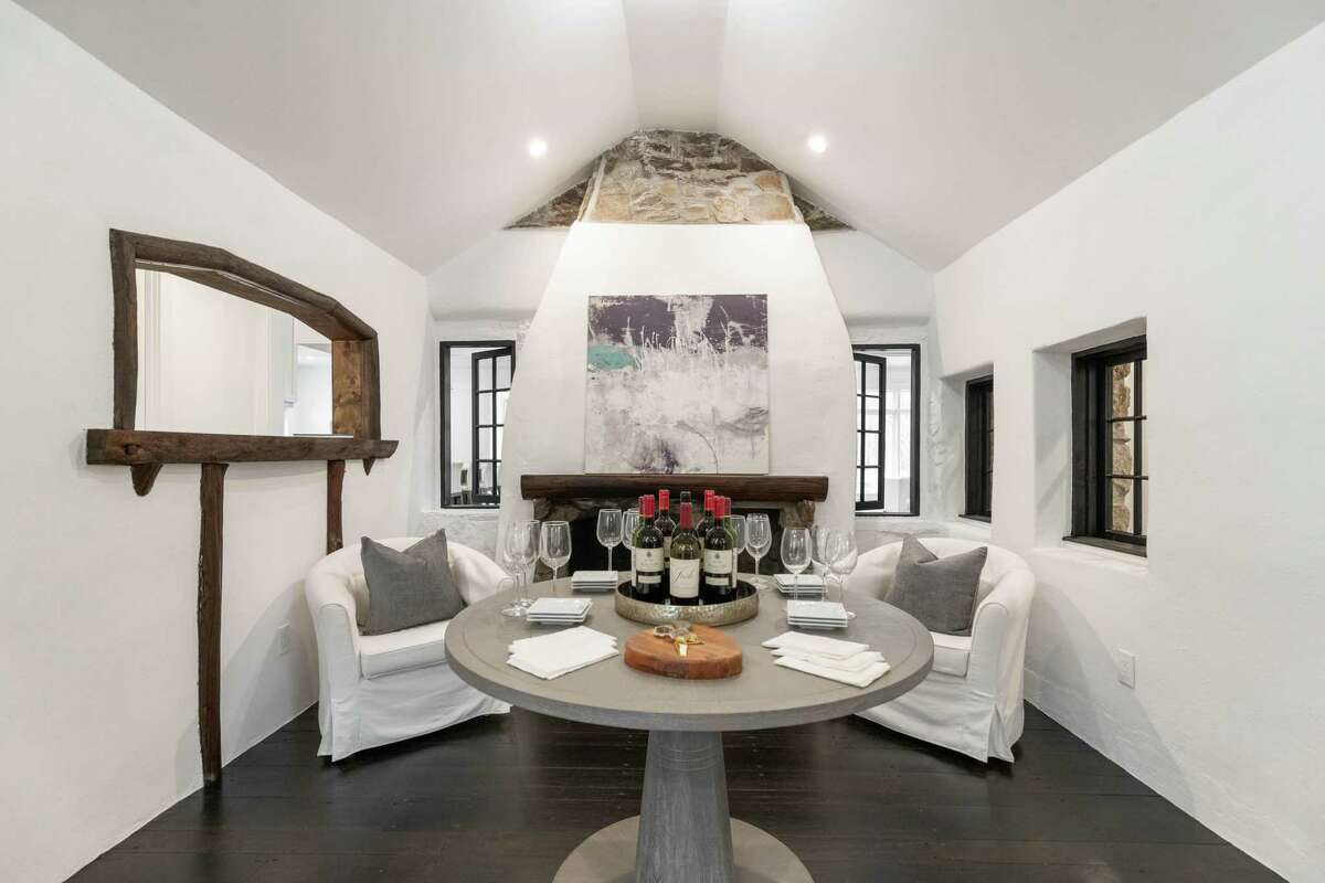 Wine tasting room with original stone fireplace at 58 Weston Woods Way, Weston.