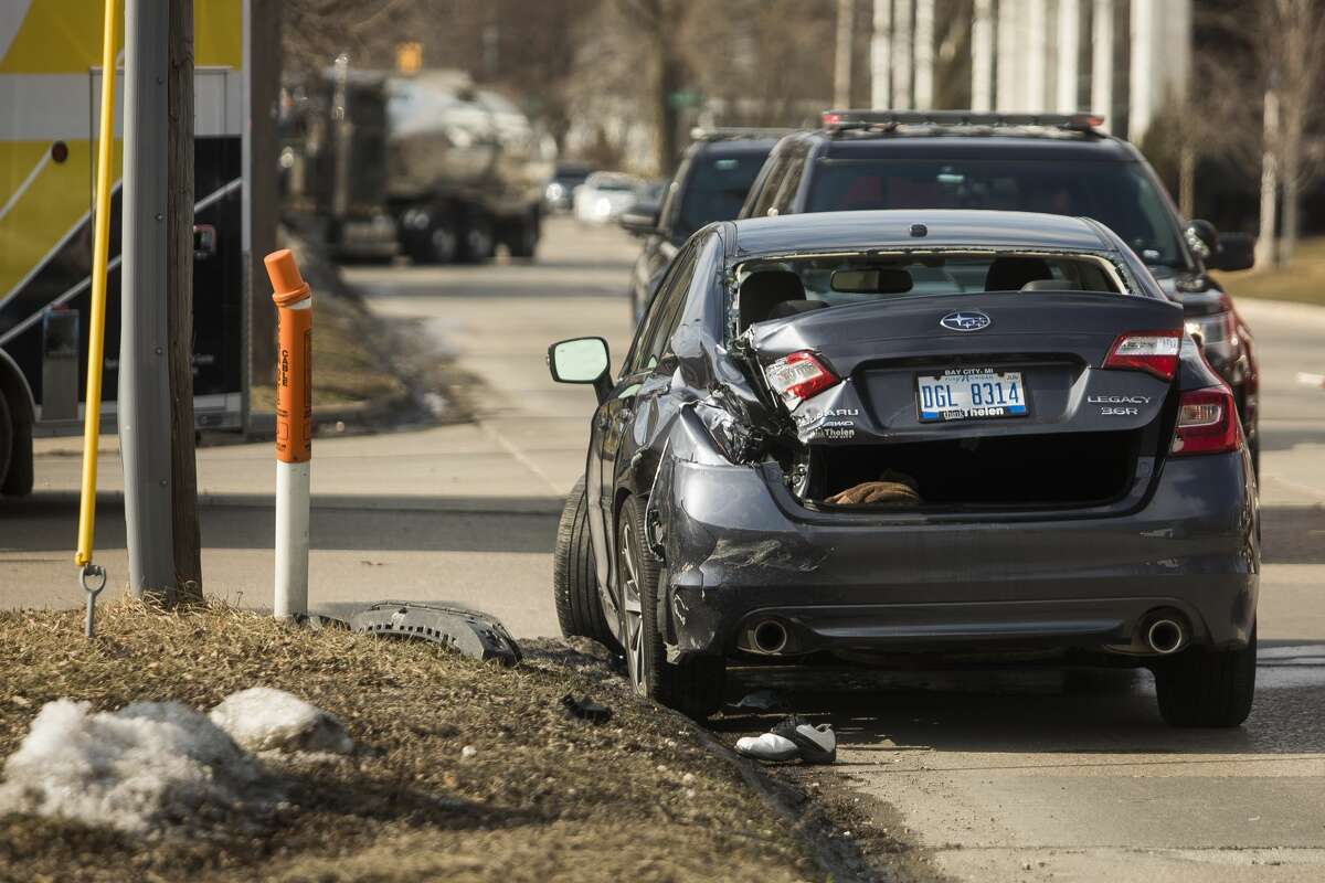 Members of the City of Midland Police and Fire Departments secure the scene of a collision at the intersection of Buttles and McDonald Streets Wednesday, March 3, 2021 in Midland. (Katy Kildee/kkildee@mdn.net)