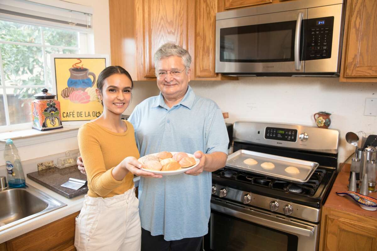 Agueda Ulloa and her father Isidro hold conchas, a Mexican sweet bread, she baked in her home oven in Union City, Calif. on March 3, 2021. She started her home business, named Cafe de la Olla, using a family recipe that she slightly tweaked.