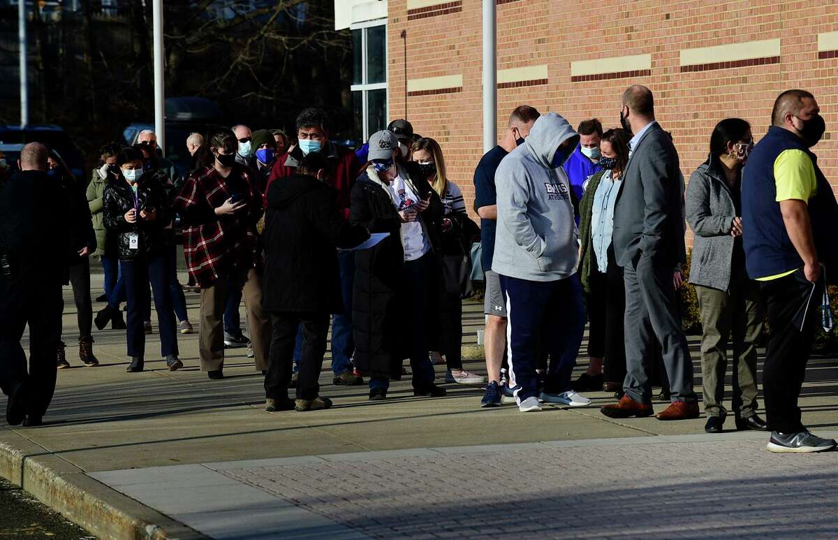 Norwalk Public Schools staff line up for the Moderna coronavirus shot.