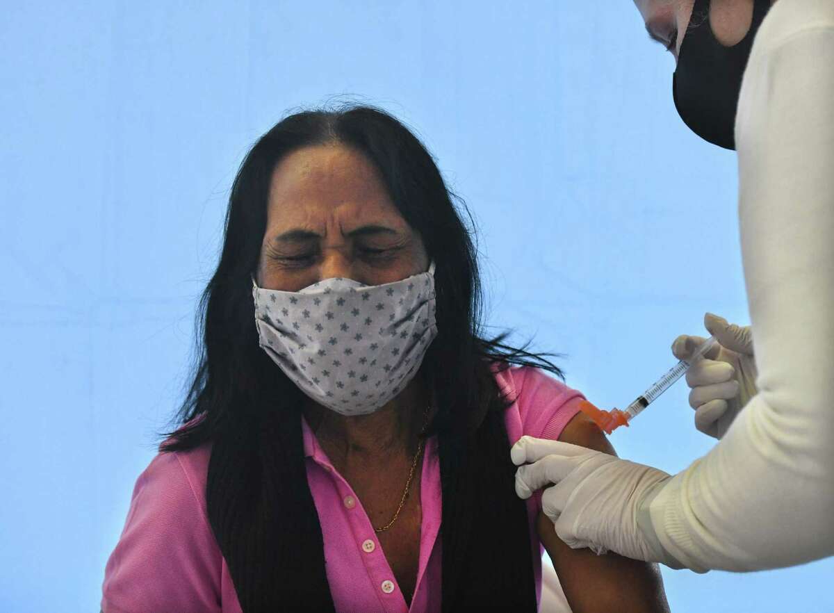 Greenwich's Georgina Lall receives the COVID-19 vaccine from Christine Plateroti, LPN, at the Family Centers vaccination clinic at the Eastern Greenwich Civic Center in Old Greenwich, Conn. Monday, March 1, 2021. March 1 marked a massive expansion of vaccine eligibility as all Connecticut residents age 55 and up are now eligibile.