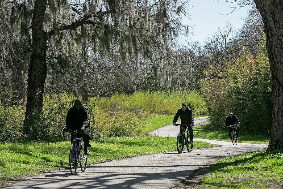 Langston Prince, from left, Jared Schoenvogel and Rudy Terrazas ride on the Salado Creek Greenway, part of the Howard W. Peak Greenway Trails System, during their lunch break on Tuesday, March 2, 2021. The chairman of the local linear creeks committee says the city is becoming recognized as a destination for cyclists.