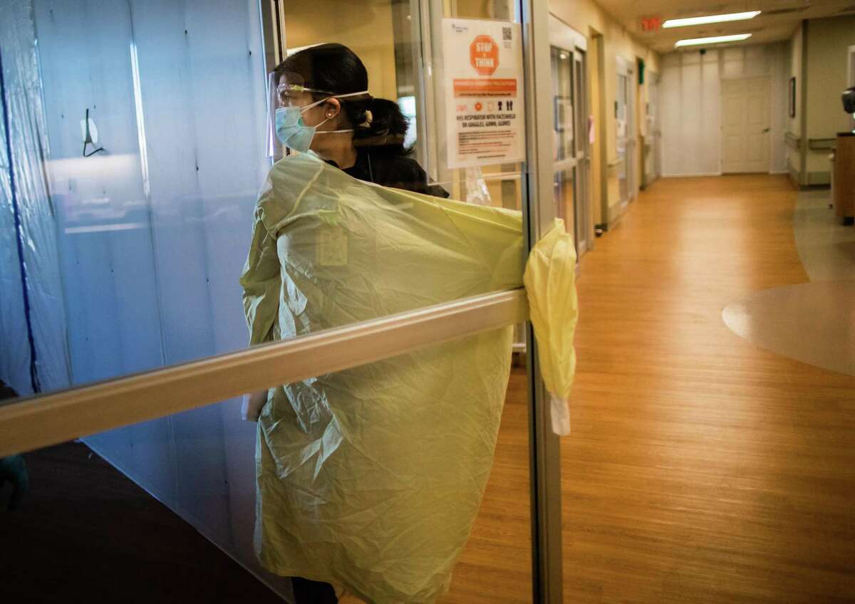 CHI St. Luke's Health-Sugar Land pulmonologist Dr. Manpreet Mangat enters the room of a patient during her morning rounds at an intense care unit, Wednesday, March 3, 2021, in Sugar Land.