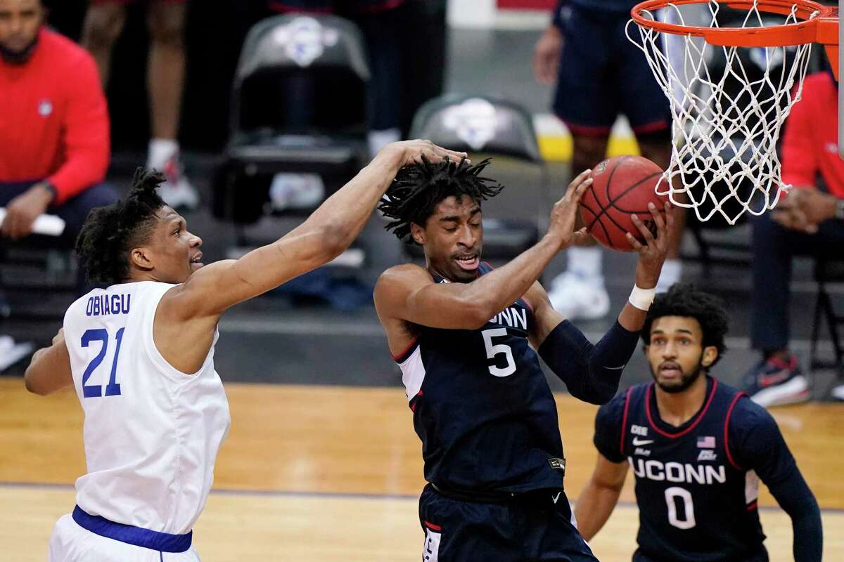 UConn’s Isaiah Whaley pulls down a rebound against Seton Hall as teammate Jalen Gaffney (0) watches during the first half on Wednesday in Newark, N.J.