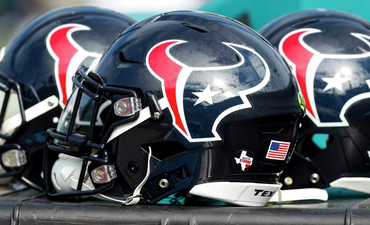 A trio of Houston Texans helmets sit on the sideoines before an NFL football game against the Jacksonville Jaguars at EverBank Field on Sunday, Dec. 17, 2017, in Jacksonville.