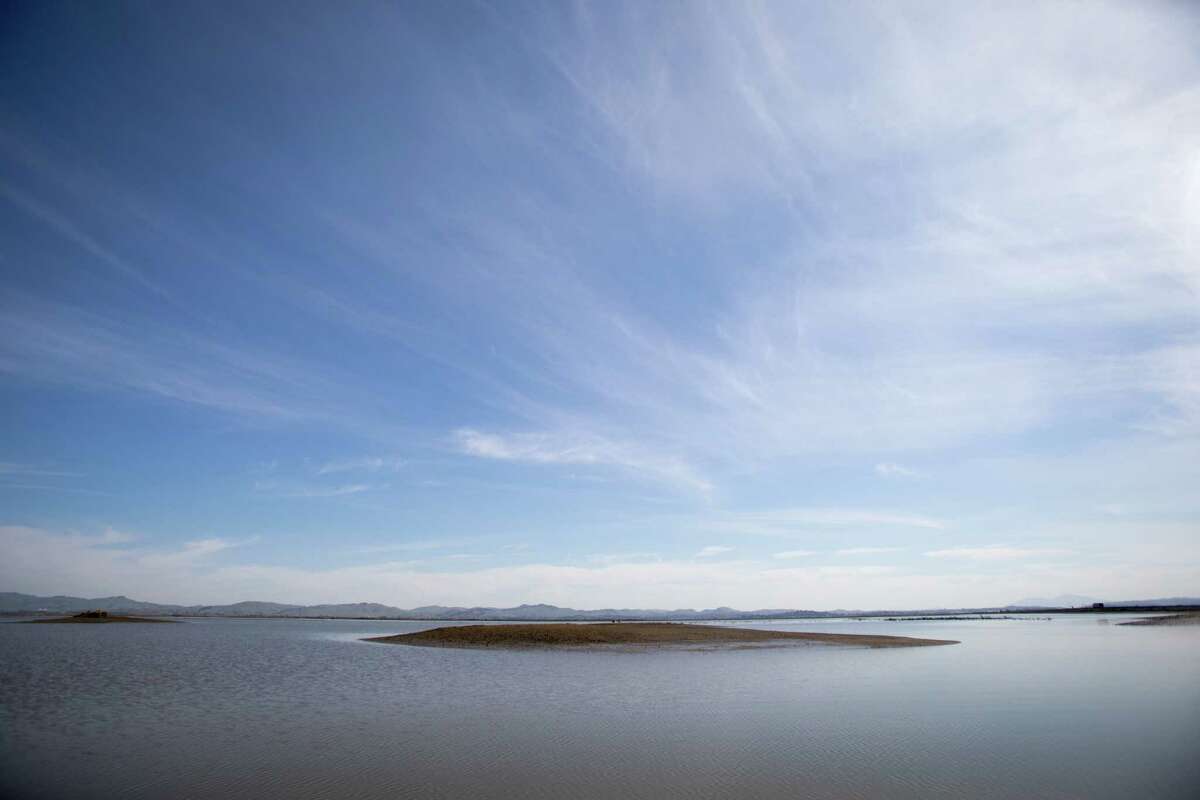 An island of sediment is visible at low tide at Cullinan Ranch near Vallejo, Calif., on March 3, 2021. Part of San Pablo Bay National Wildlife Refuge, Cullinan Ranch is former farmland that is being restored into a tidal marsh.