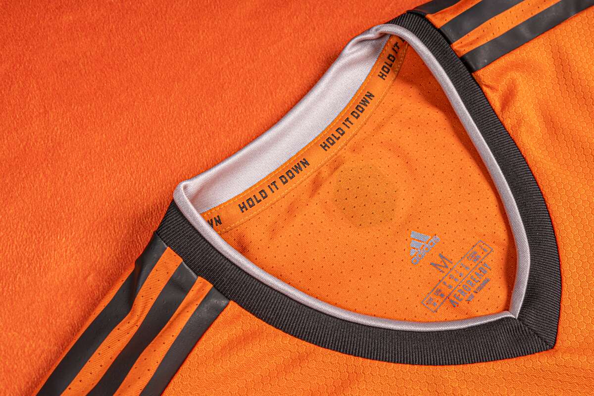 The motto of the Houston Dynamo Football Club "Lower it" inside the neckline of the new 2021 season jerseys.