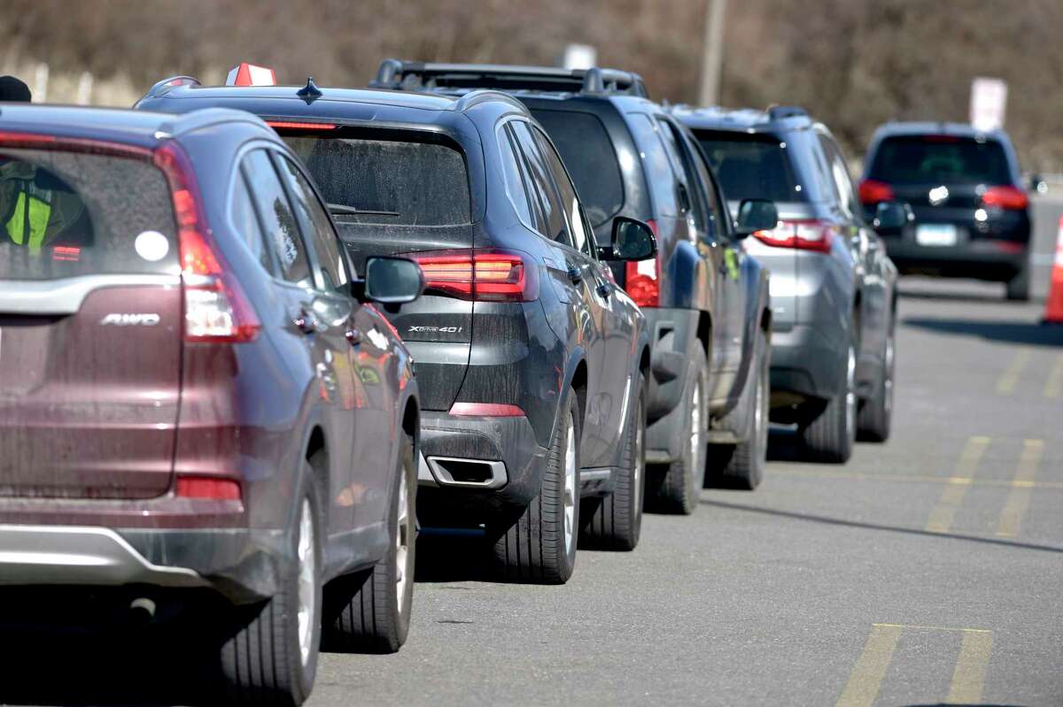 People wait after receiving their vaccinations at Danbury's first mass COVID-19 vaccination site which opened on Thursday at the Danbury Fair mall. The Community Health Center, Inc site will utilize six car lanes to serve 600 appointments a day. March 4, 2021, in Danbury, Conn.