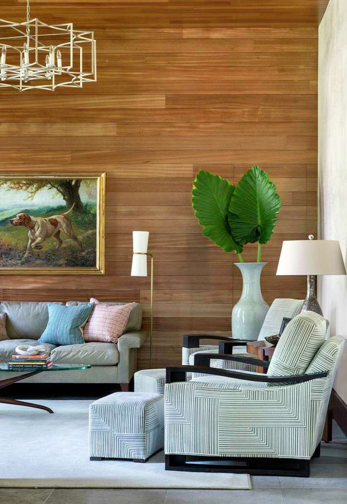 Bleached mahogany paneling covers two walls and the ceiling in the study or TV room.