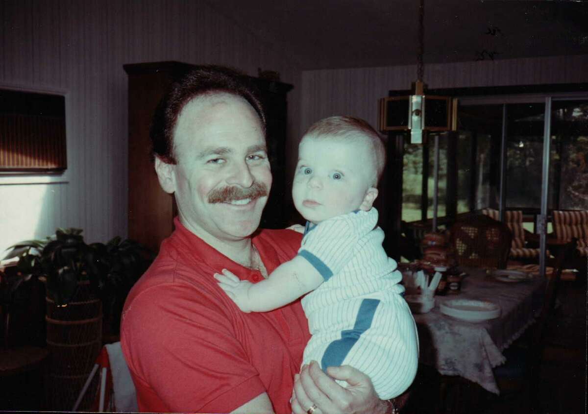 Michael Reiter holding his son Adam as an infant.