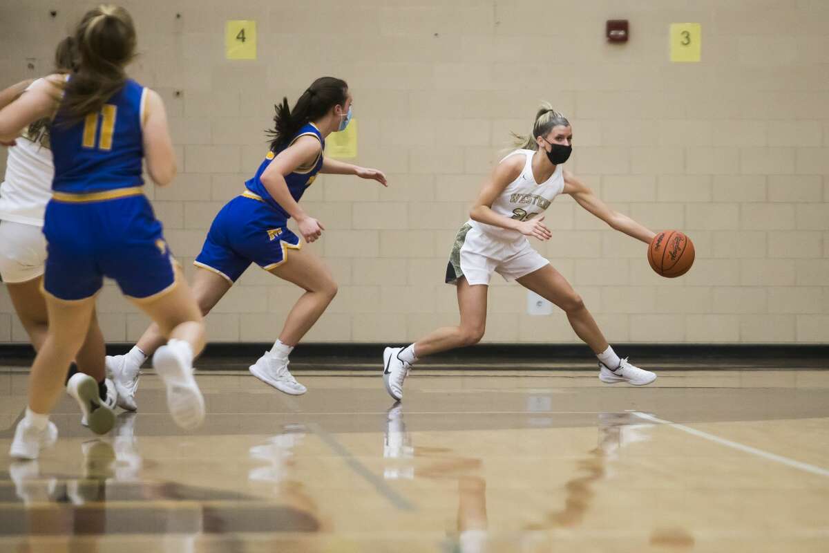 Bay City Western's Megan Lukowski dribbles down the court during the Warriors' game against Midland Thursday, March 4, 2021 at Western. (Katy Kildee/kkildee@mdn.net)