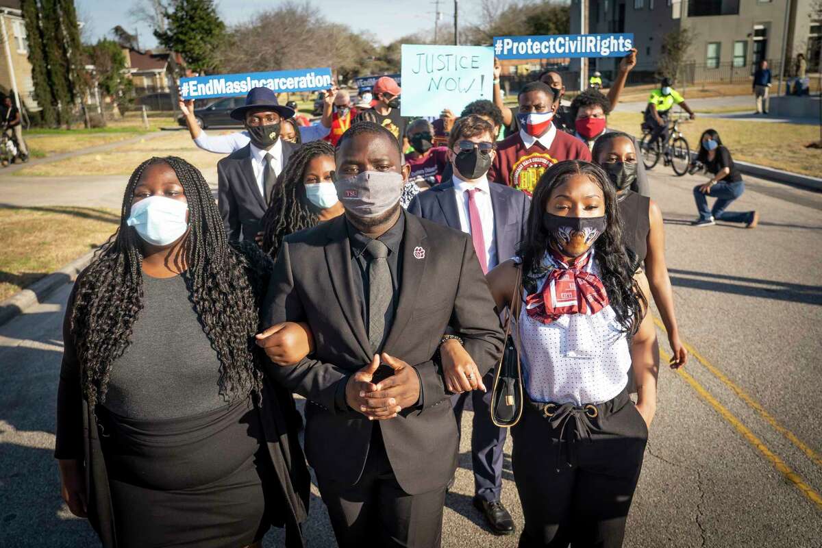 Texas Southern University students Brittney Sheppard, Nahab Fahnbulleh and Khaniya Burley join fellow members of the TSU debate team and members of the TSU student government marching down Cleburne Street, Thursday, March 4, 2021, in Houston. The students, along with alumni, activists and community leaders, were commemorating the March 4, 1960 sit-in led by 13 Texas Southern Students at a Weingarten’s grocery store that started a sit-in movement aimed towards desegregating Houston. The sit-in at Weingarten’s Supermarket was the first in a series of non-violent demonstrations that ultimately lead to the peaceful end of segregation in public places. Houston’s lunch counters quietly desegregated on August 25, 1960, according to the Texas Historical Commission.