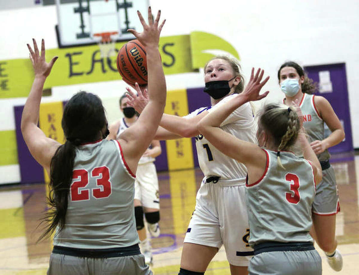CM’s Tori Standefer puts up a shot in the lane over Highland’s Liv Wilke (3) and Taylor Kesner (23) in Mississippi Valley Conference girls basketball action Thursday in Bethalto.