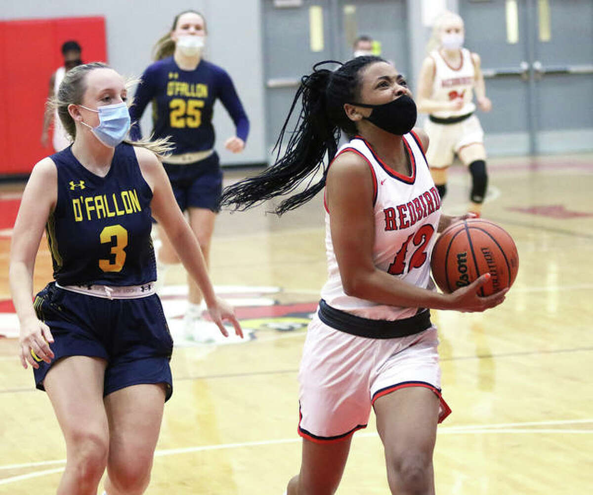 Alton’s Germayia Wallace (right), shown beating O’Fallon’s Klaire Keel to the basket on a break in a SWC game Feb. 11 in Godfrey, scored a team-high nine points in the Redbirds’ loss Thursday night at Belleville West.