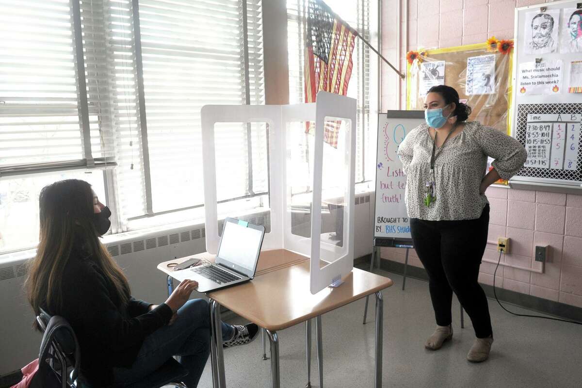World history teacher Michelle Scatamacchia speaks with freshman Adrianna Nunez during the question and answer session of a special Black history presentation at Bunnell High School, in Stratford, Conn. March 4, 2021. Current students and faculty also watched an online panel discussion given by Black alumni from the school.