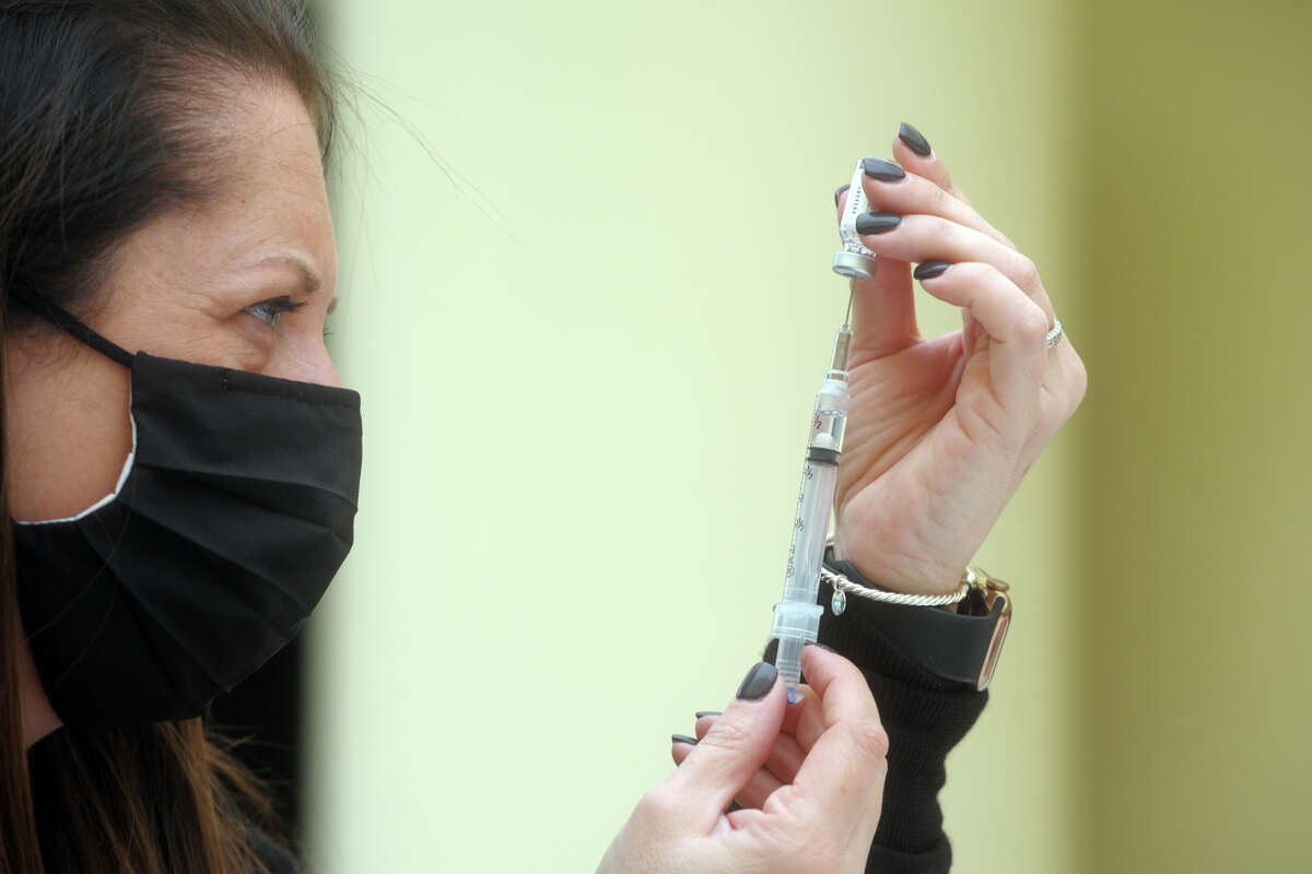 Megan Murphy, Emergency Management Director for the Town of Trumbull, fills syringes with the new Johnson & Johnson COVID-19 vaccine during the vaccination clinic held for teachers and school staff in Trumbull, Conn. March 4, 2021.
