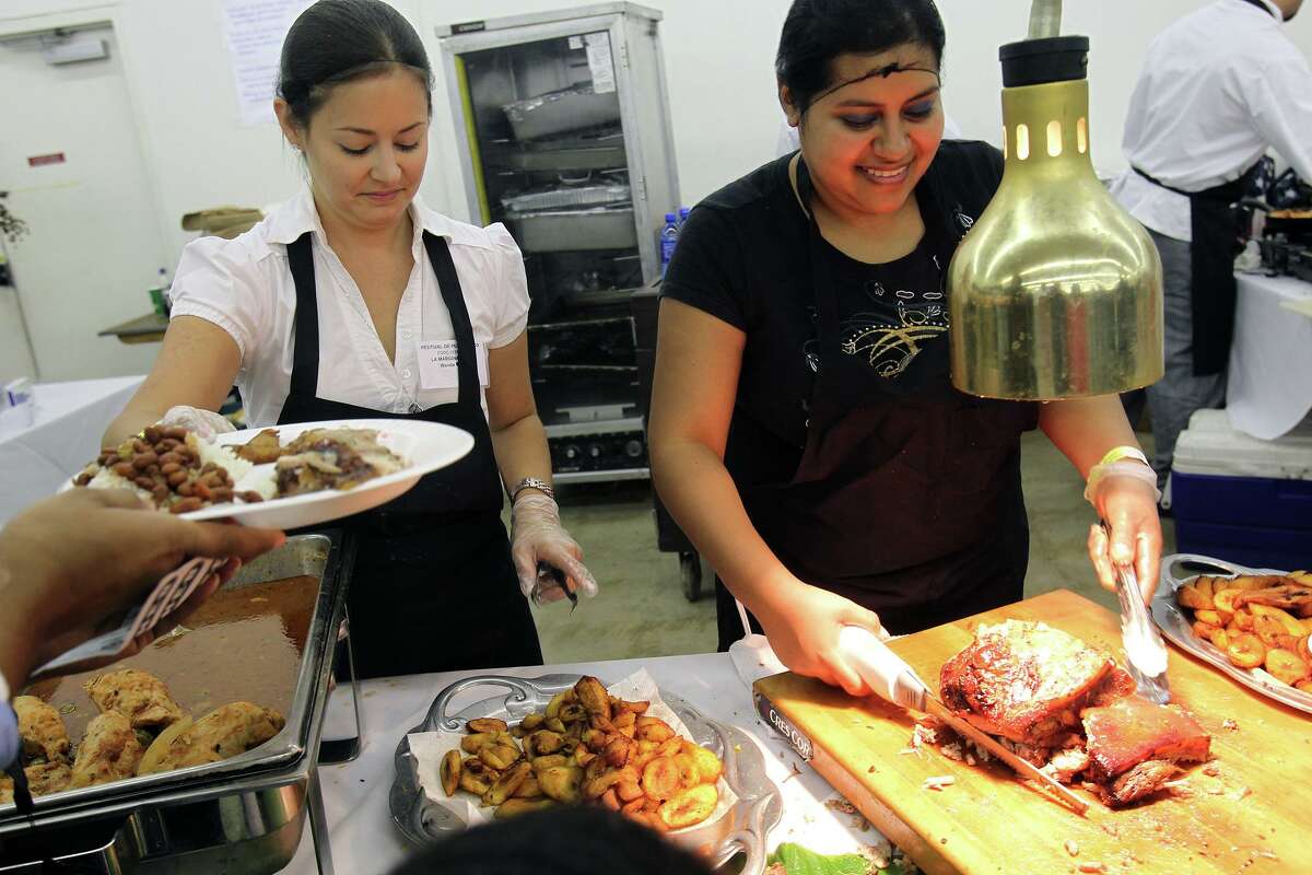 To establish credible legitimacy with his clientele, Leonel Alvarez traveled to Puerto Rico and spent several weeks totally immersed in the island’s unique culture. He died at 50 last month of COVID-19. In this 2010 photo, employees serve up traditional Puerto Rican food.