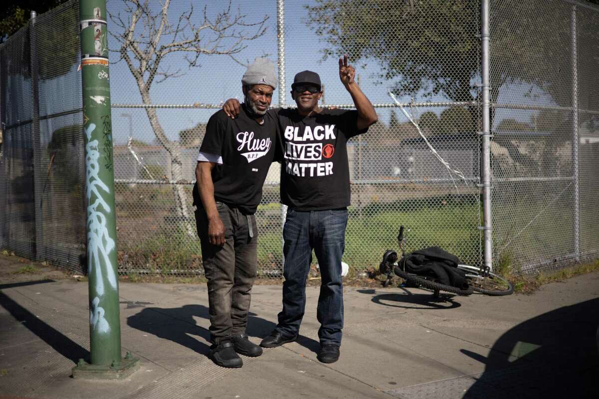 Demetrius “Hook” Mitchell (left) stands with his friend, James Candley, in his boyhood neighborhood in West Oakland on March 4, 2021.