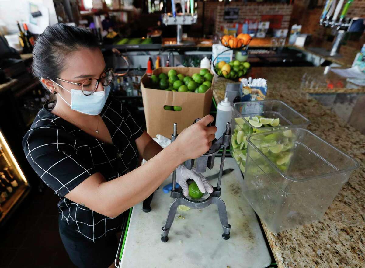 Bartender Meagan Oliver cuts limes at Fajita Jack's Tex-Mex Grill and Cantina, Saturday, June 27, 2020, in Montgomery. Local restaurant have endured fluctuating capacity levels in the last year and will finally return to 100 percent capacity on Wednesday.