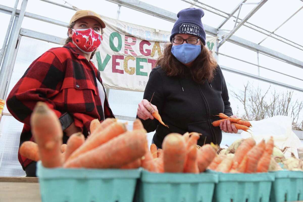 Mackenzie Brant, left, and Laura Markowicz, of Riverbank Farm of Roxbury, one of the original vendors at the Westport Farmers' Market on Thursday, March 4, 2021, in Westport, Conn.
