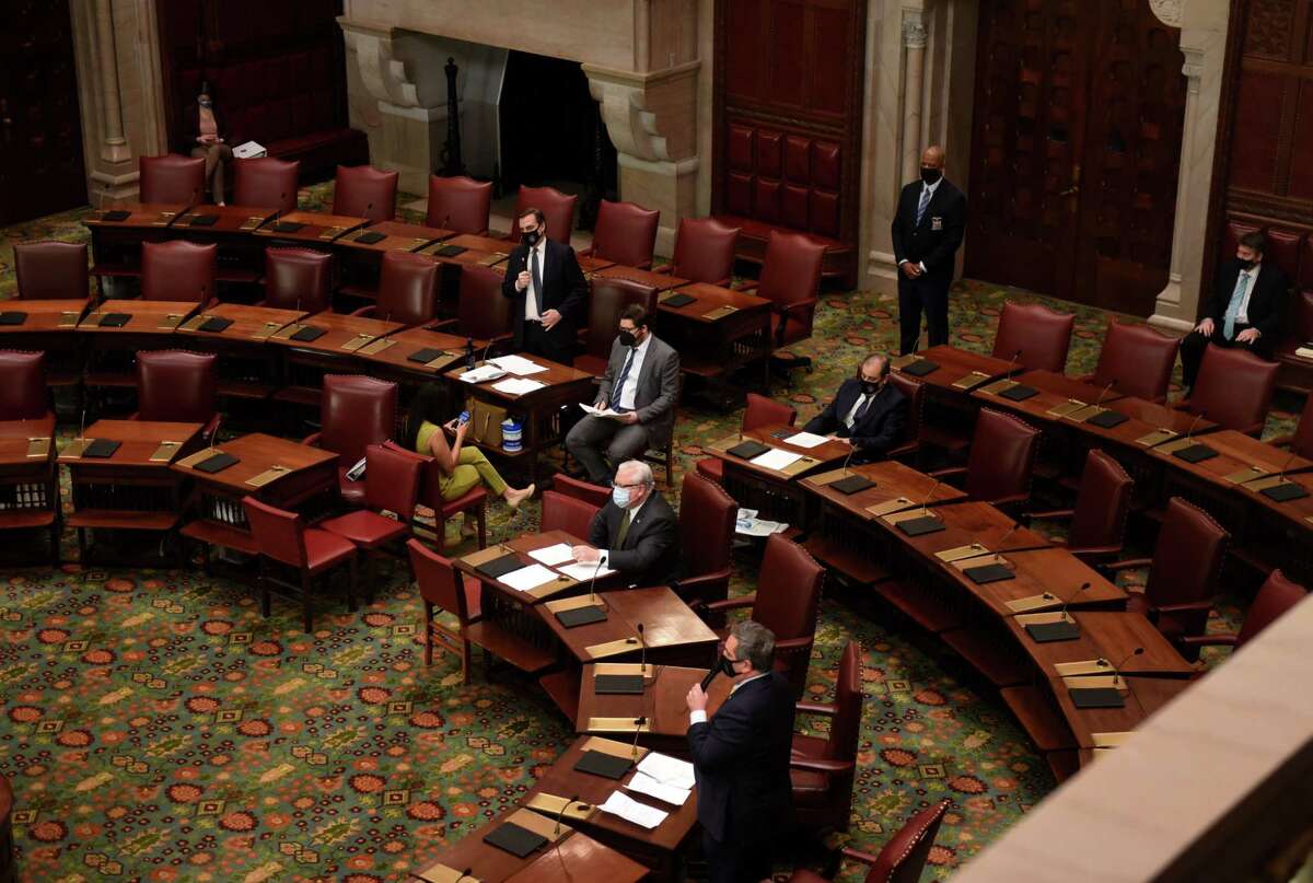 New York Senate Deputy Majority Leader Michael Gianaris, top, answers questions from Sen. George Borrello, bottom, during a vote to repeal temporary emergency powers granted to the Governor last year at the start of the COVID-19 pandemic on Friday, March 5, 2021, at the Capitol in Albany, N.Y. (Will Waldron/Times Union)