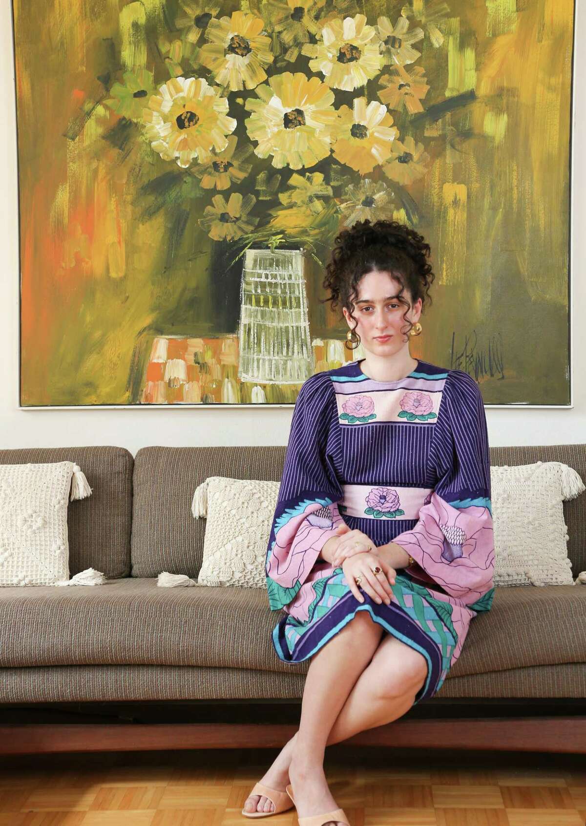 University Houston student Olivia Haroutounian wears a vintage dress from her mom in her family's living room in Houston on Friday, Jan. 29, 2021.